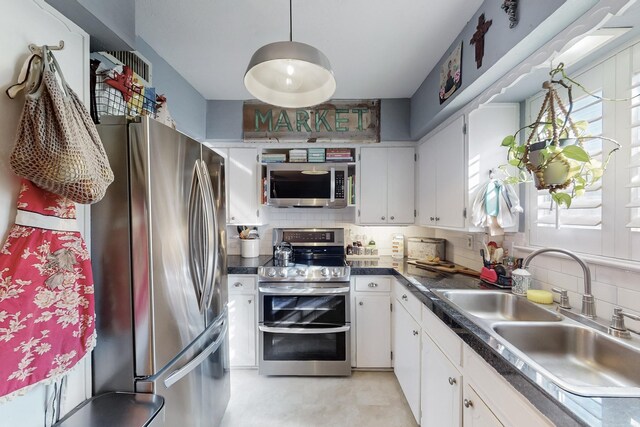 kitchen featuring tasteful backsplash, white cabinetry, sink, and light parquet floors