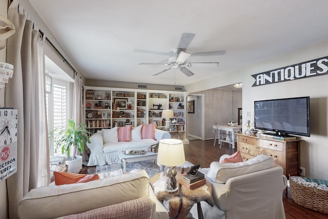 living room featuring hardwood / wood-style floors and ceiling fan