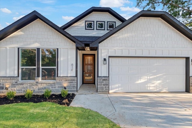 craftsman house with a front yard and a garage