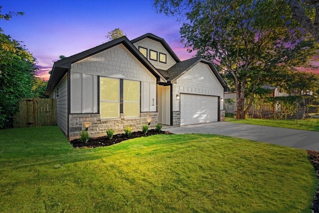 view of front of house with a garage and a yard