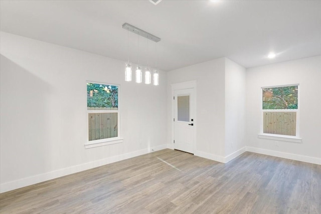 spare room with hardwood / wood-style floors