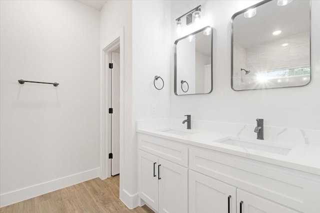 bathroom with hardwood / wood-style floors and vanity