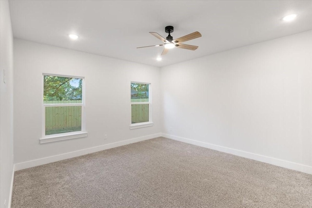 unfurnished room featuring ceiling fan, carpet floors, and a healthy amount of sunlight