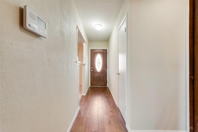 doorway with wood-type flooring