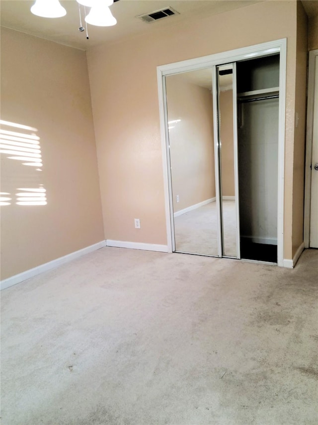 unfurnished bedroom featuring light colored carpet