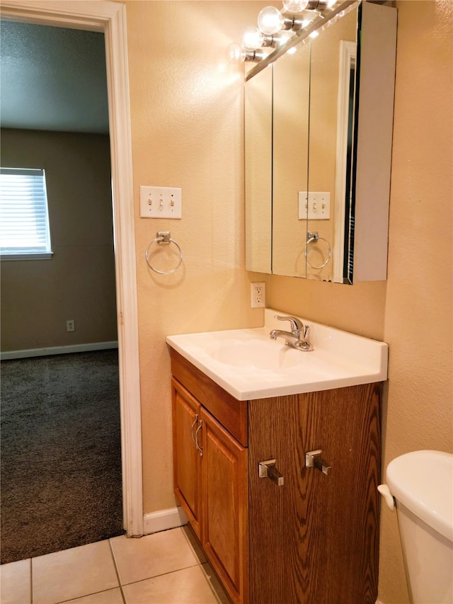 bathroom featuring tile patterned flooring, vanity, and toilet