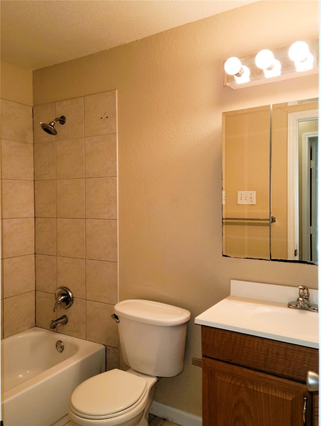 full bathroom featuring vanity, toilet, and tiled shower / bath