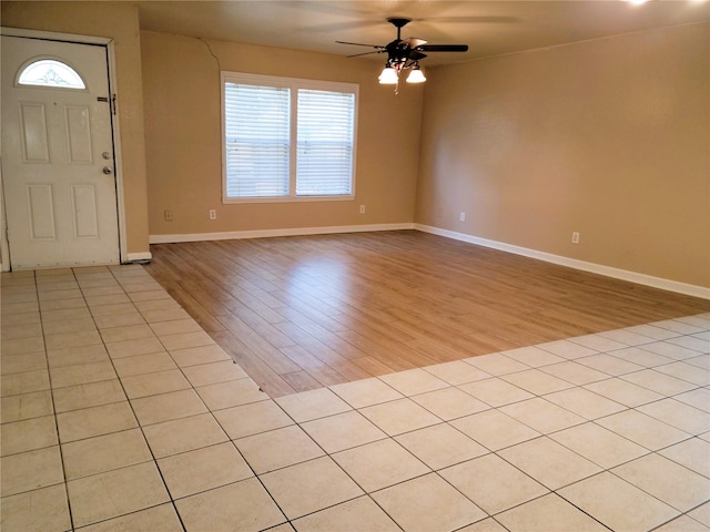 tiled entrance foyer featuring ceiling fan