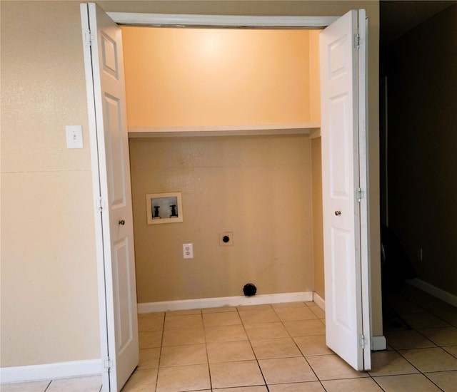 washroom with electric dryer hookup, light tile patterned flooring, and hookup for a washing machine