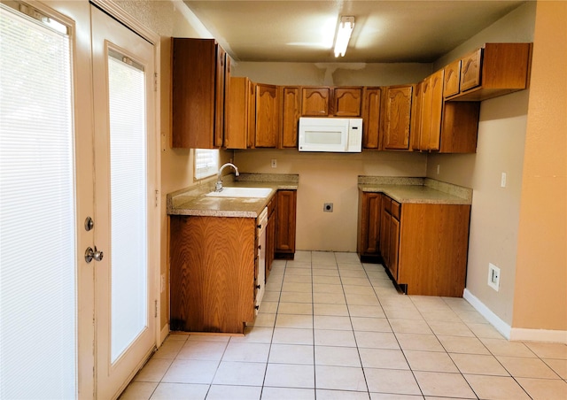 kitchen featuring light tile patterned flooring and sink