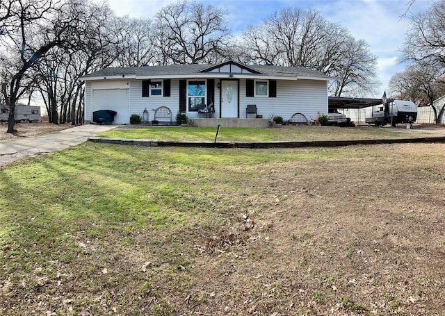 ranch-style house with a carport, a garage, and a front yard