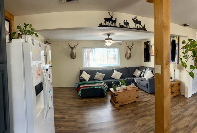 living room featuring ceiling fan and dark hardwood / wood-style flooring