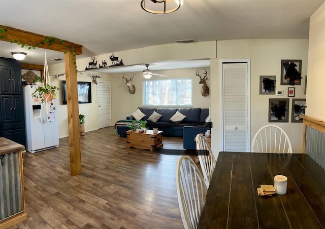 dining space with ceiling fan and dark wood-type flooring