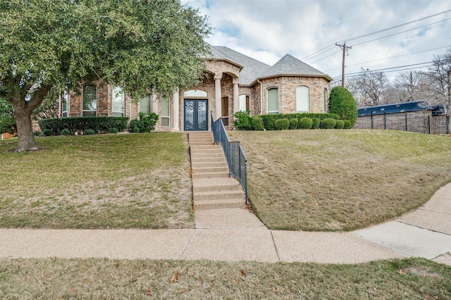 view of front facade with french doors and a front lawn