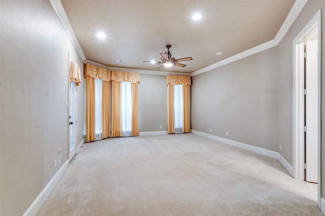 carpeted spare room with ceiling fan and ornamental molding