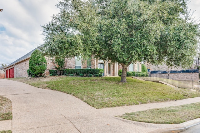 view of property hidden behind natural elements with a front yard