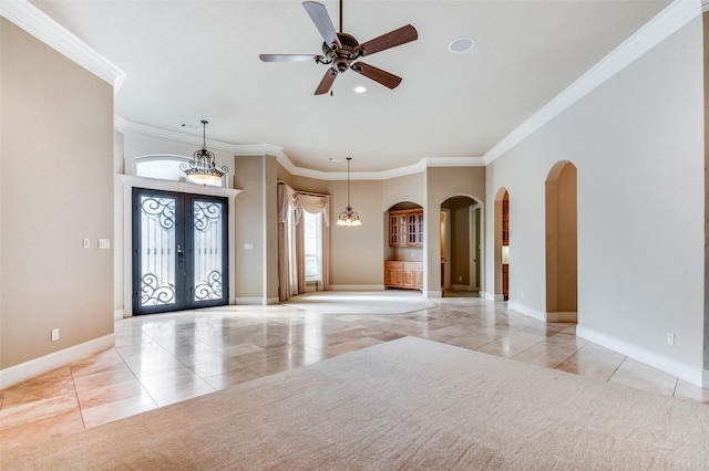 tiled entryway featuring french doors, ceiling fan, and ornamental molding