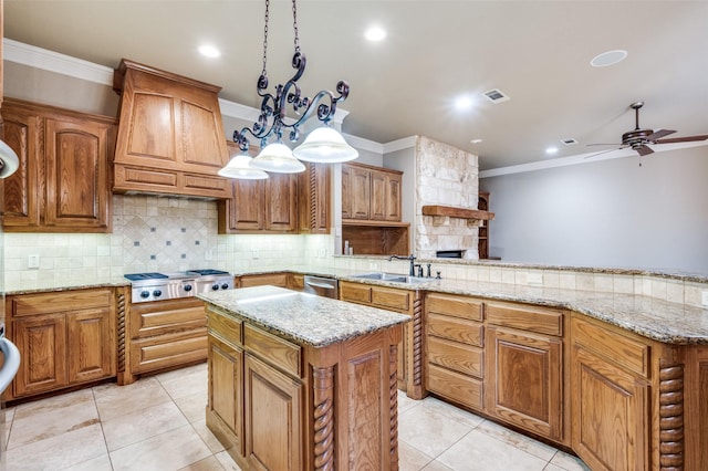 kitchen featuring appliances with stainless steel finishes, a kitchen island, decorative light fixtures, sink, and custom exhaust hood