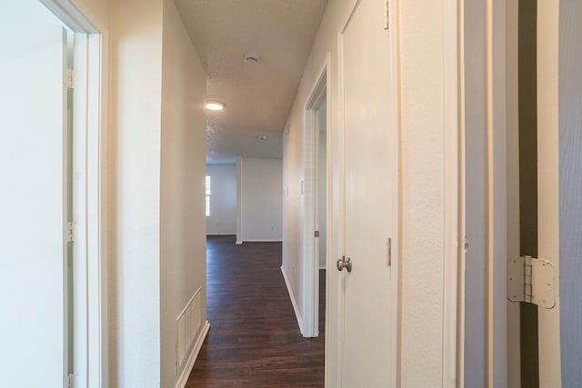 corridor with dark hardwood / wood-style floors