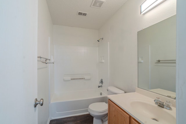 full bathroom featuring bathtub / shower combination, toilet, a textured ceiling, vanity, and hardwood / wood-style flooring