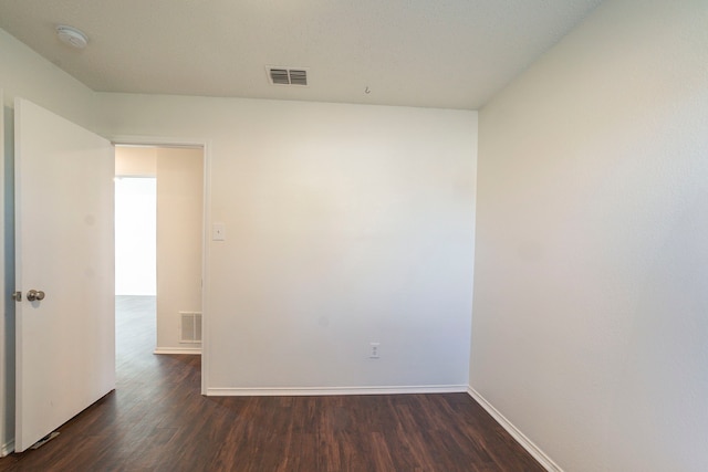 empty room featuring dark hardwood / wood-style floors