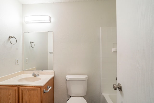 full bathroom with vanity, toilet, and washtub / shower combination