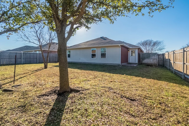 back of house featuring a yard