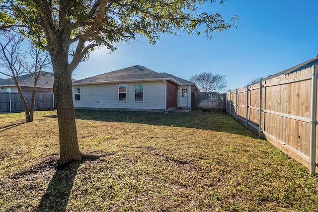 rear view of house featuring a lawn