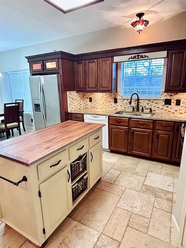 kitchen featuring sink, stainless steel fridge, dishwasher, and cream cabinetry