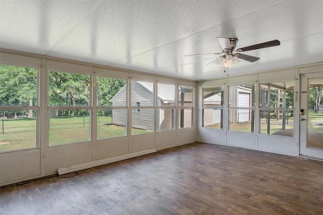 unfurnished sunroom with a baseboard radiator and ceiling fan