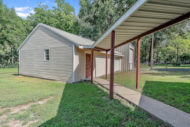 view of front of house with a garage, an outbuilding, and a front yard