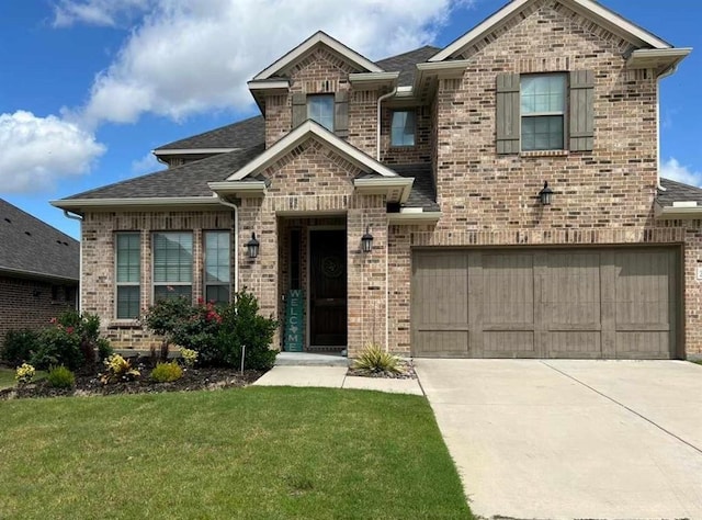 view of front of home featuring a garage and a front lawn