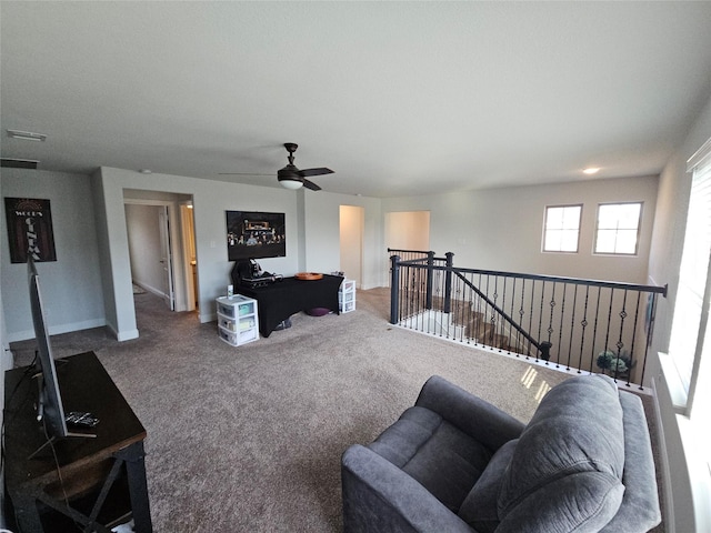 carpeted living room with ceiling fan