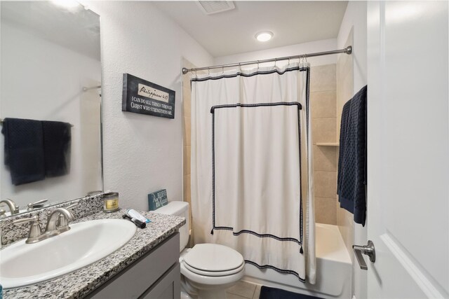 full bathroom with tile patterned floors, vanity, shower / tub combo, and toilet