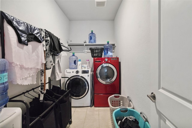 laundry area with light tile patterned flooring and independent washer and dryer