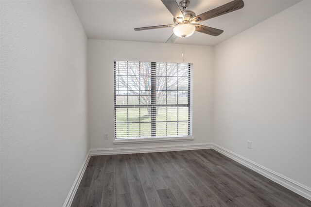 spare room featuring dark hardwood / wood-style floors and ceiling fan