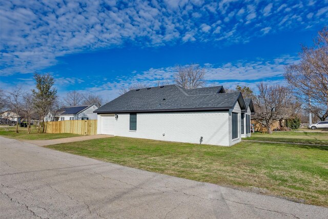 view of side of property with a lawn