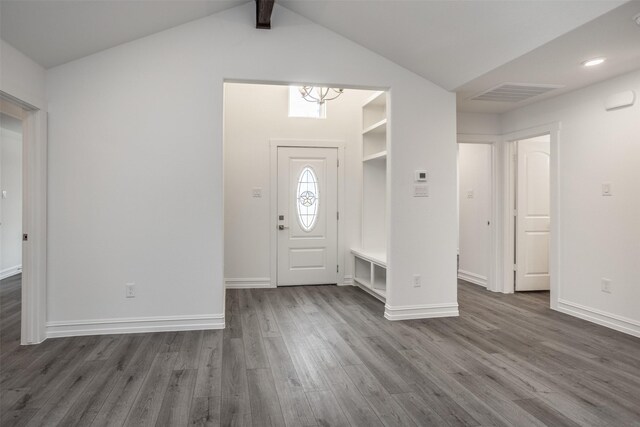 entrance foyer with a chandelier, vaulted ceiling with beams, and dark hardwood / wood-style flooring