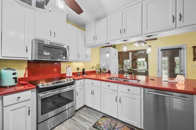 kitchen with white cabinets, sink, and appliances with stainless steel finishes