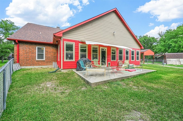 rear view of property featuring a yard and a patio