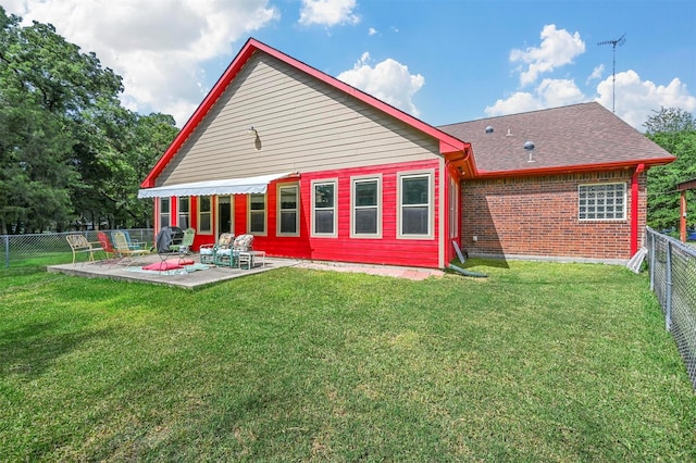 back of house featuring a patio area and a yard