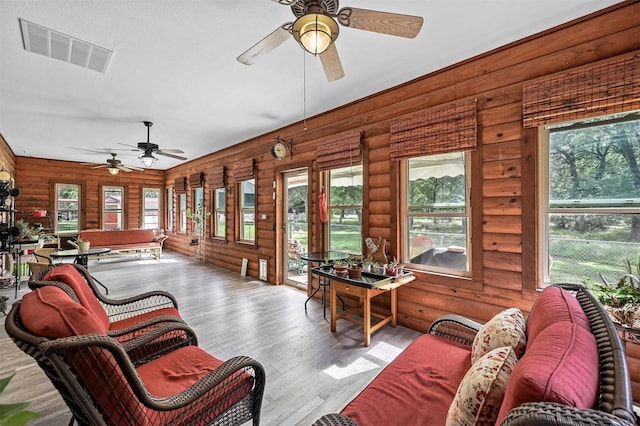 sunroom / solarium featuring ceiling fan