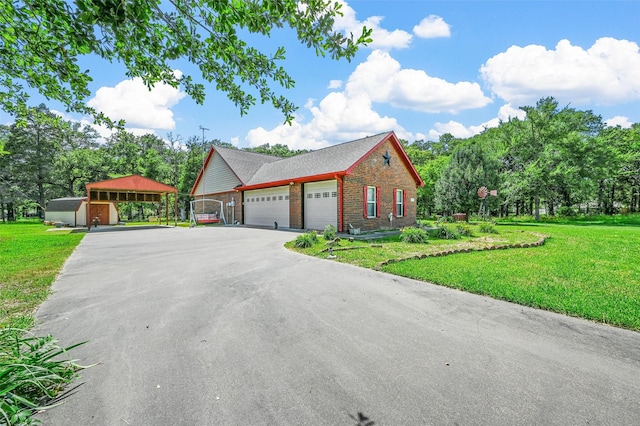 view of front of home featuring a carport, a garage, and a front lawn