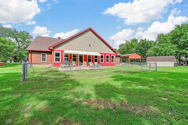 rear view of property with a yard