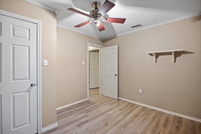 unfurnished bedroom with ceiling fan, light wood-type flooring, and ornamental molding