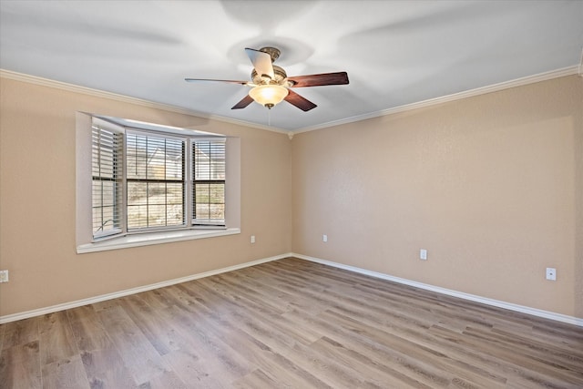 empty room featuring ceiling fan, light wood-type flooring, and ornamental molding