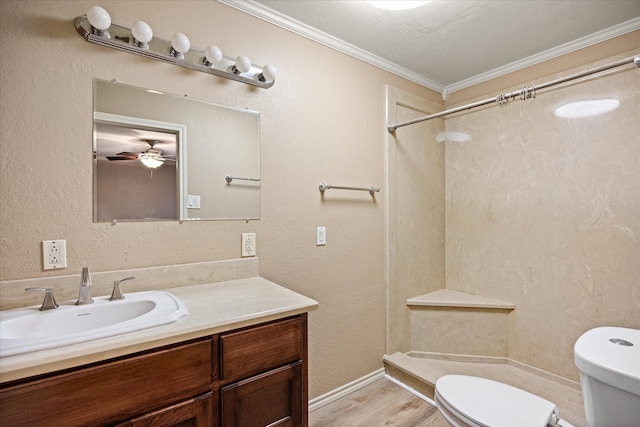 bathroom with a shower, toilet, hardwood / wood-style floors, and ornamental molding