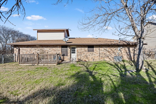 rear view of property with a lawn and a deck