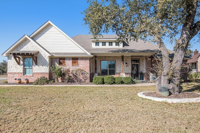 view of front of house featuring a front yard and brick siding