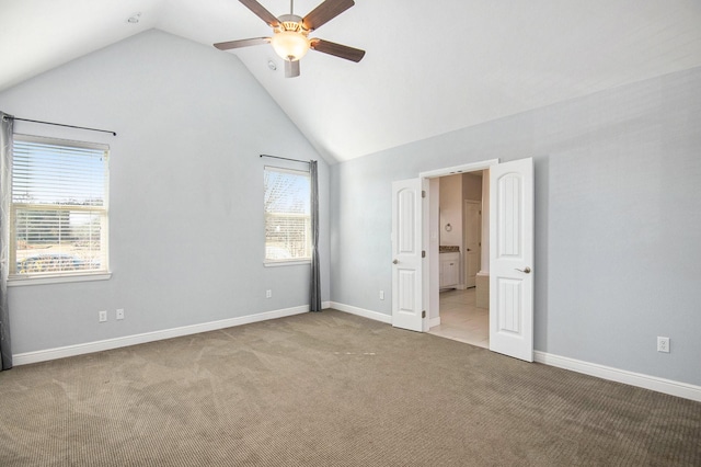 unfurnished bedroom with ceiling fan, lofted ceiling, and light carpet